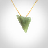 This is a lovely New Zealand Jade, pounamu niho drop pendant. It is bound with an adjustable beige coloured cord which is length adjustable.